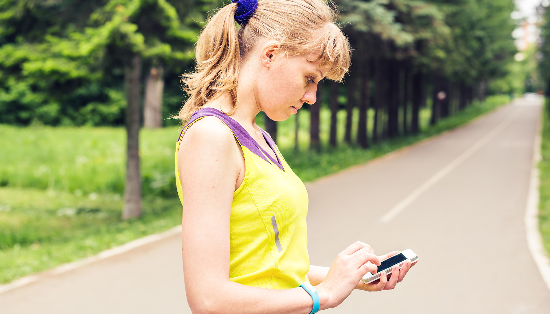 Person using a fitness app on their smartphone, raising concerns about privacy and data security.