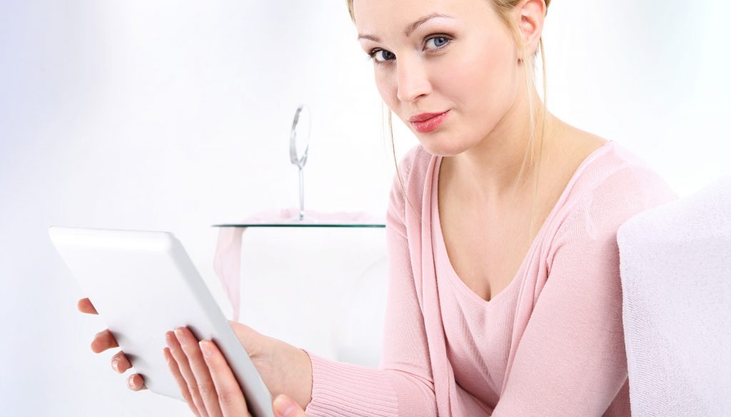 Woman using a tablet for browsing and online privacy.