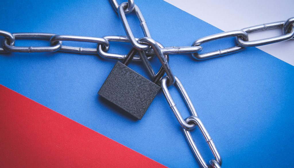 Chains and padlock on the Russian flag symbolizing internet restrictions.